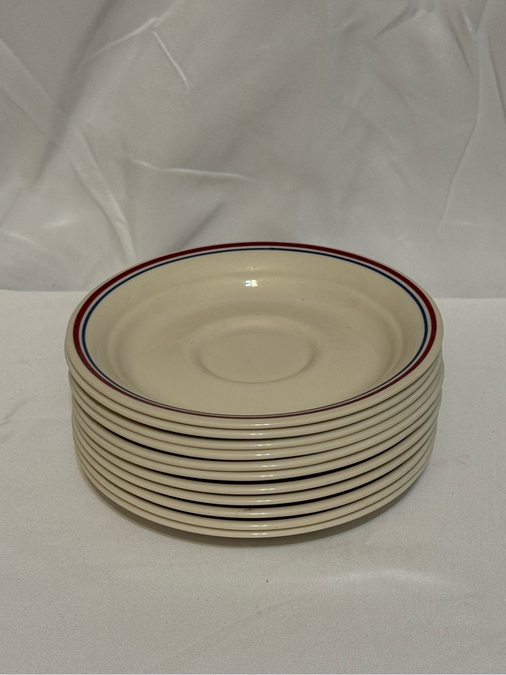 Corelle Cream Saucer Set with Red and Blue Rim Accents